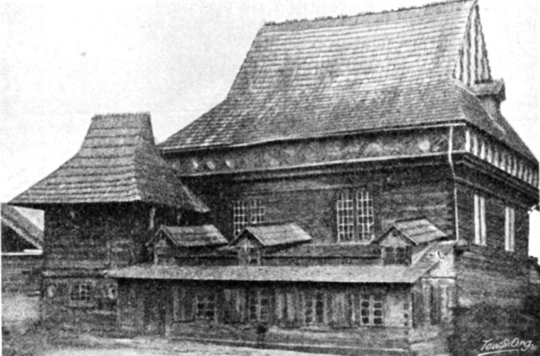 Black-and-white halftone of the timber synagogue with a steep main roof, a lower pavilion roof and a long lean-to along the front.